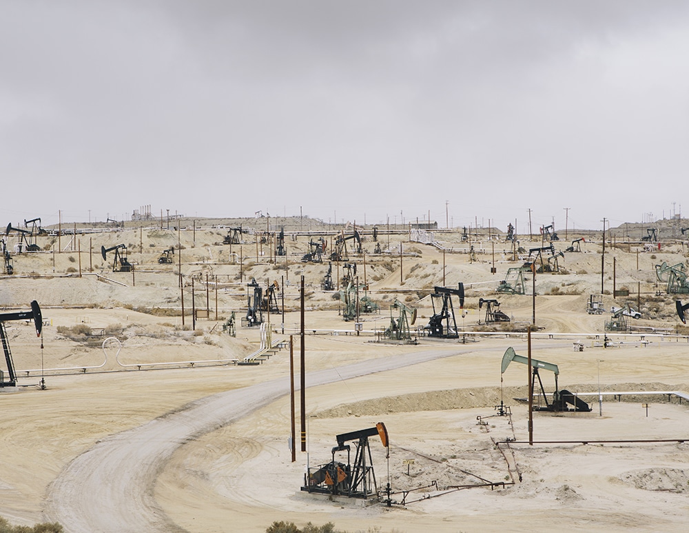 Dark, ominous clouds over oil field, Taft, CA,USA,Oil rigs and wells in the Midway-Sunset shale oil fields, the largest in California