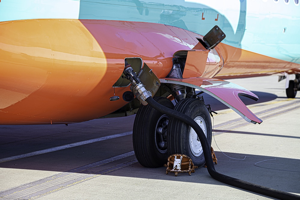 Refueling the plane. Filling tank and gun. Fuel supply through a hose. Weel.